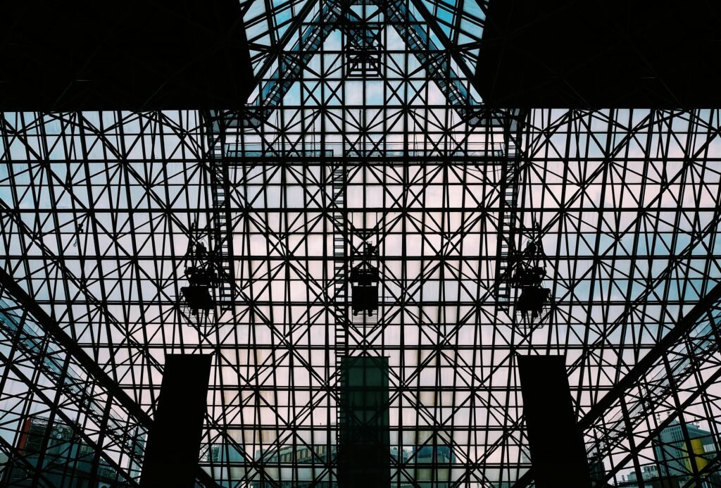 Intricate steel and glass grid structure of a modern building in Tokyo.